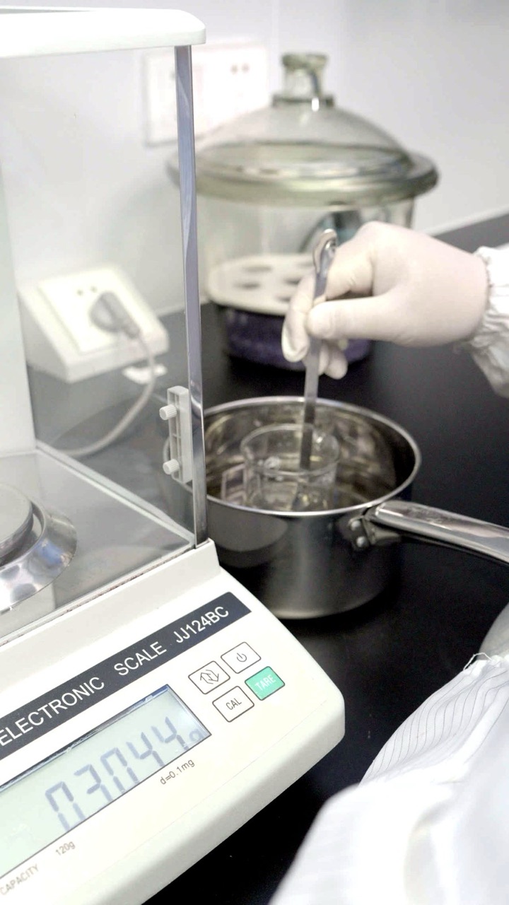 Weighing on an analytical balance at the Pepti site